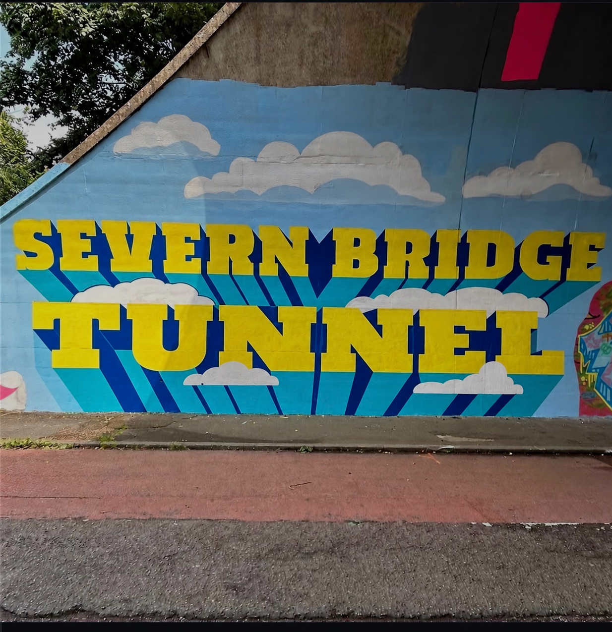 Proposed Severn Bridge Tunnel mural, with large yellow letters, long blue shadows and white clouds
